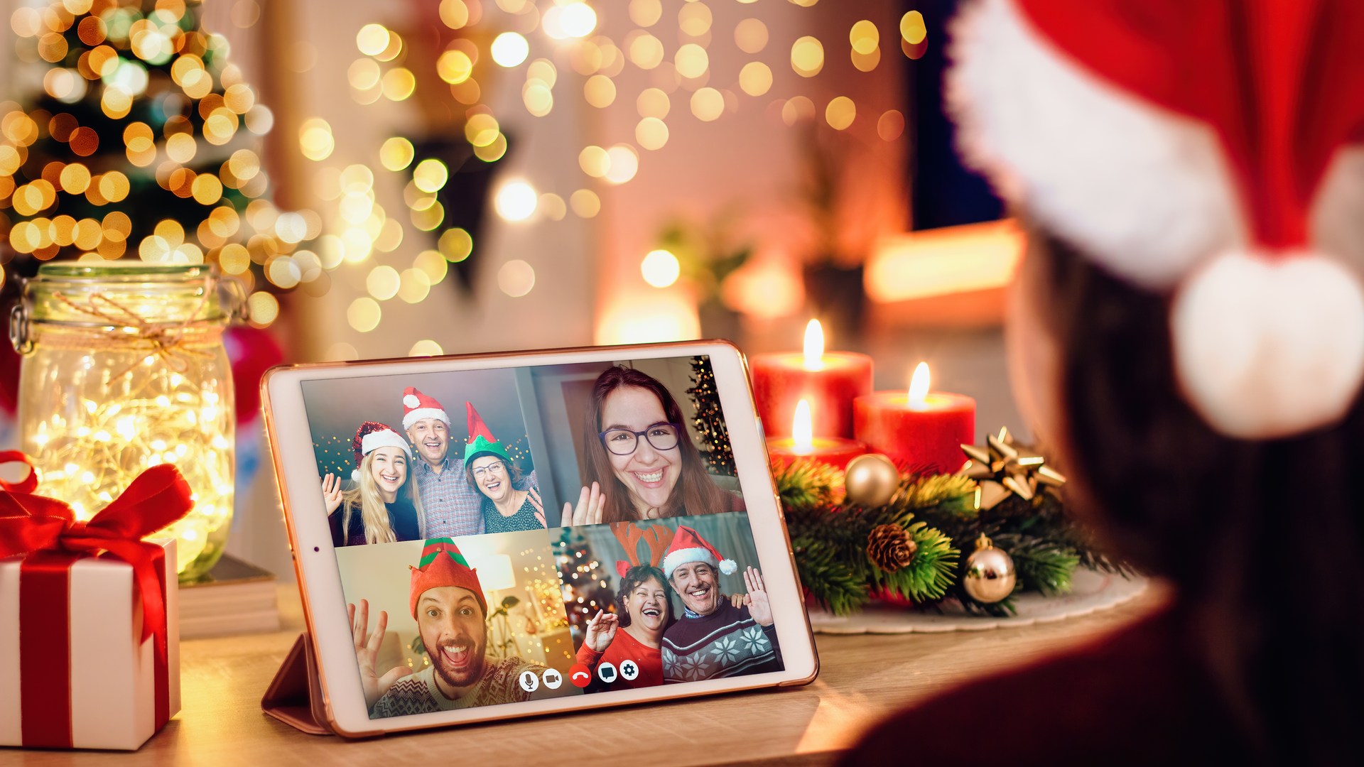 woman in Santa's hat on virtual Christmas party with family