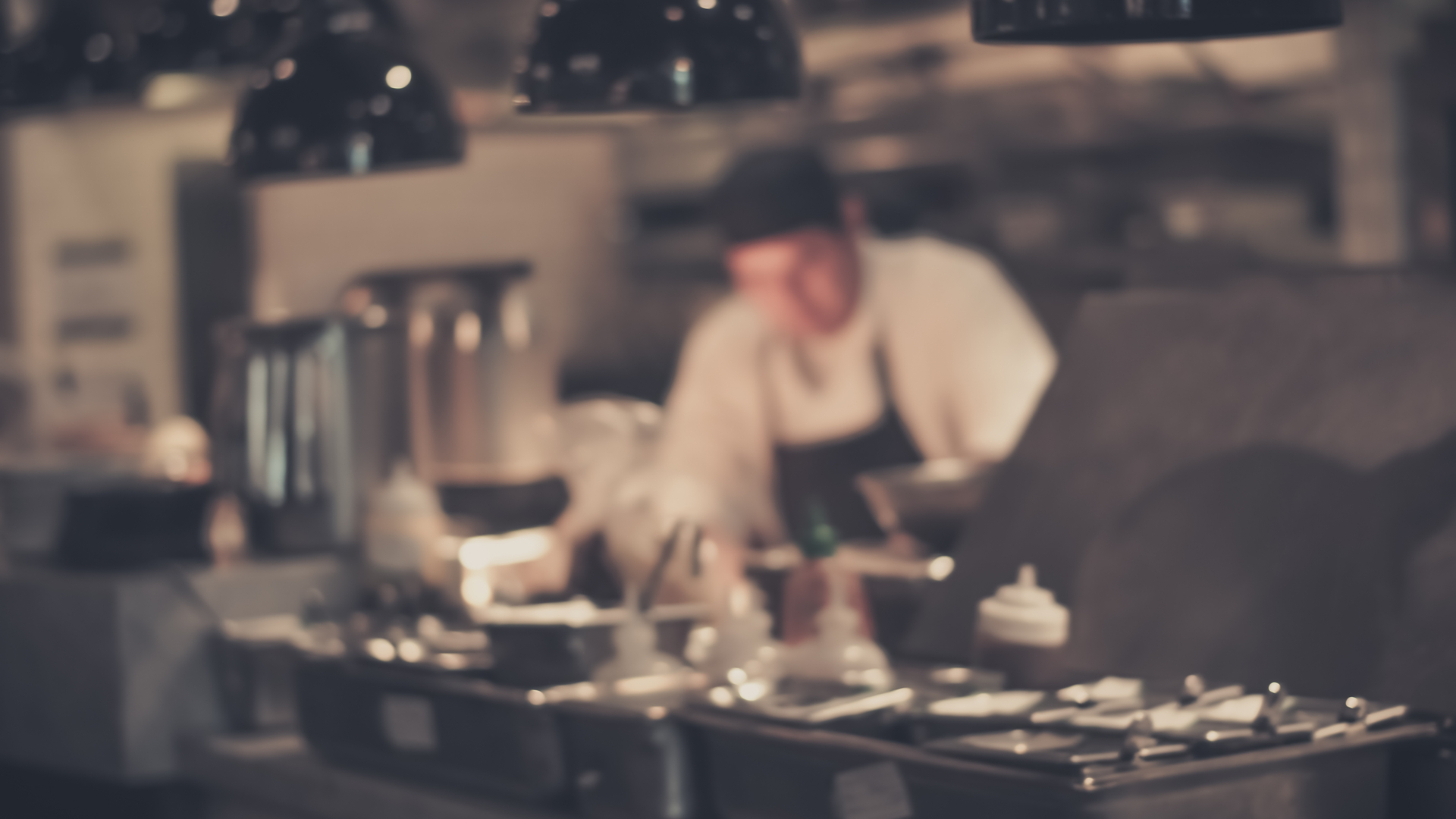 Skilled chef in a kitchen blurred